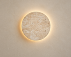 Tsuki Stone Wall Lamp, warm lit studio view
